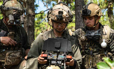 about_us-jiop-design Soldiers in the field flying drone