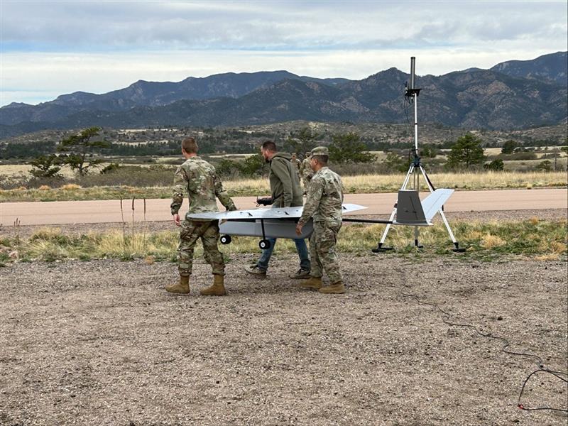 Soldiers carrying a drone